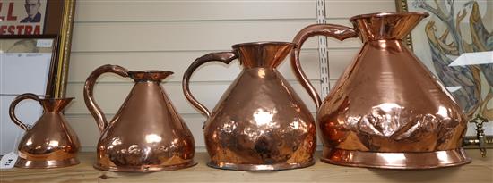A set of four graduated copper jugs (one 4 gallon with tap)